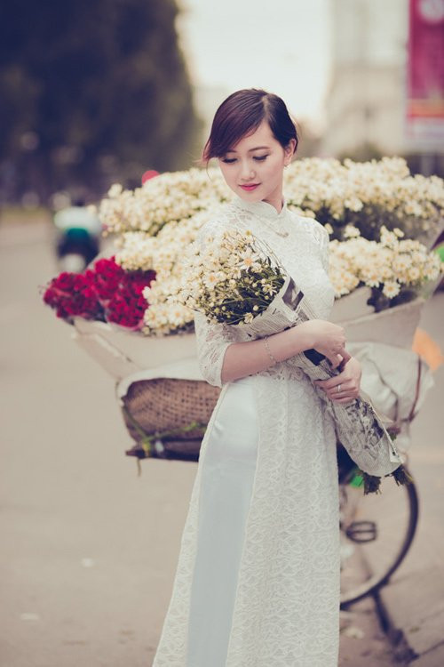 Những thiếu nữ Hà thành cũng tranh thủ dịp này, diện áo dài, váy vóc, đứng bên cúc họa mi chụp ảnh kỷ niệm. Sự e ấp, dịu dàng của các cô gái kết hợp với sự tinh khôi của cúc họa mi tạo nên vẻ đẹp say lòng người. Ảnh: Sự xuất hiện của thiếu nữ xinh đẹp cùng chiếc xe chở đầy họa mi trắng khiến phố phường Hà Nội trở nên bình yên hơn.