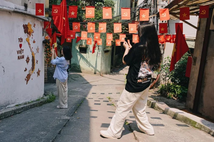 Con ngõ nhỏ còn xuất hiện thêm hình ảnh bản đồ Việt Nam với dòng chữ “Tôi yêu Việt Nam” trong thời gian gần đây. Điều này đã trở thành nét đặc sắc thu hút các bạn trẻ muốn check-in cùng mỗi khi đặt chân đến. Tuy nhiên, với cái nóng gay gắt gần 40 độ C của Hà Nội, nhiều người đã phải rất chật vật và tốn khá nhiều thời gian để có thể chụp nên một bức hình đẹp.