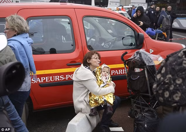 Người phụ nữ ôm con nhỏ sau khi được sơ tán khỏi sân bay Orly hôm 18/3.