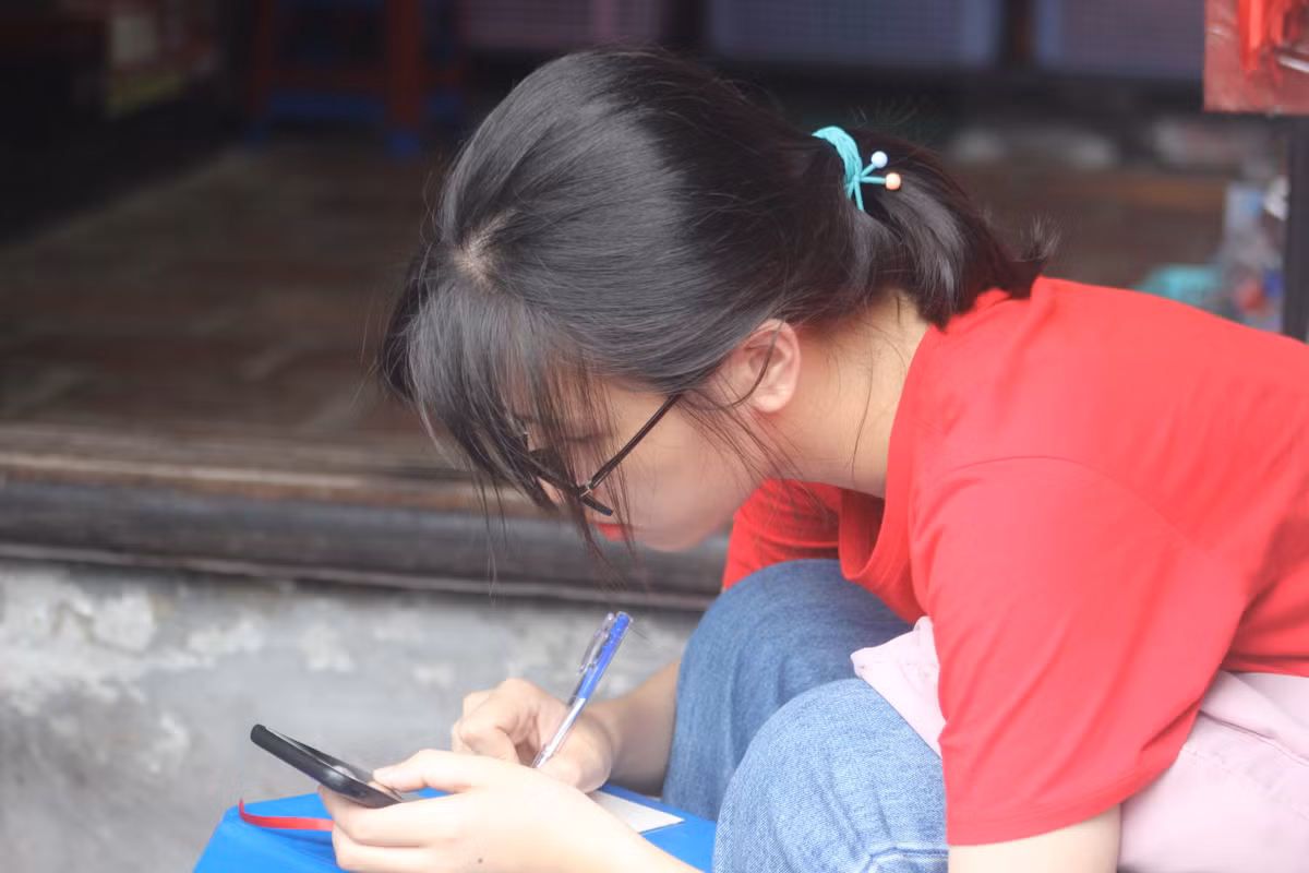 Phụ huynh mang theo giấy ghi tên thí sinh, khi hành lễ kính cẩn kêu thật to tên con mình. Nhiều em học sinh đi theo nhóm, đến nơi cũng mang theo giấy thi, viết thêm nguyện vọng vào giấy trước khi vào thắp hương để cầu may mắn.