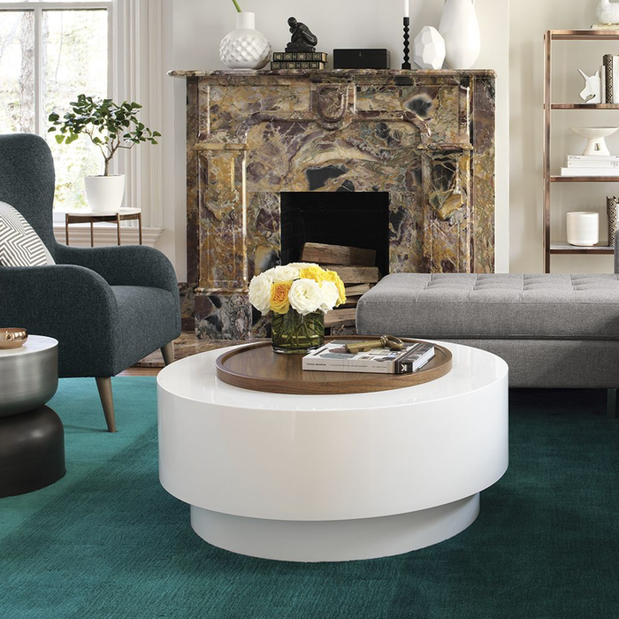 Chiếc bàn cà phê này trông giống như một chiếc bàn tròn thông thường màu trắng với khay gỗ bên trên. Nhưng thực tế, khi chiếc khay gỗ được nhấc lên, bạn sẽ thấy một không gian rỗng ở bên dưới.