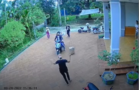 Vừa nghe tin con trai trở về đột ngột, người mẹ đã dùng gậy dài đuổi con chạy sắp sân. Nam thanh niên có phần hoảng hốt nên chỉ có thể chạy vòng quanh xe máy để tránh chiếc gậy mẹ cầm.