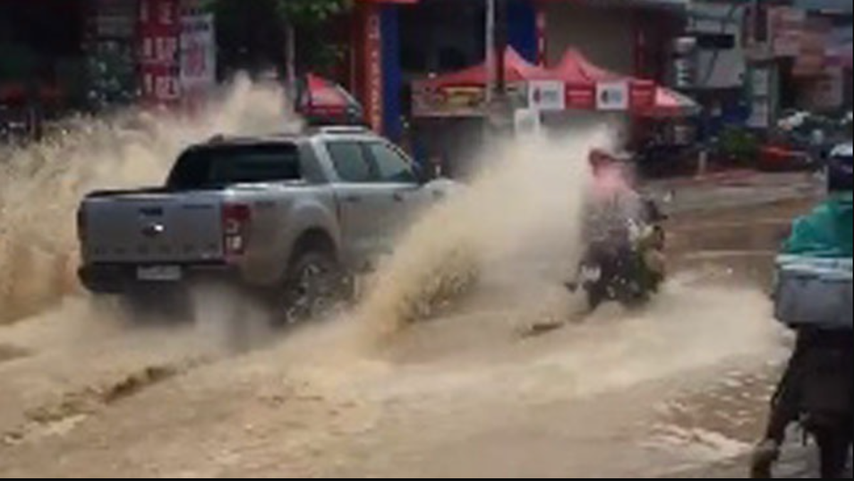 Nhiều người đi xe máy, đi bộ vô tình hứng trọn làn nước bẩn chỉ vì ý thức kém của một số tài xế ô tô. Ảnh: Chụp màn hình