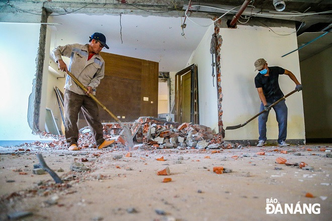 Các hạng mục công trình trái phép được công nhân tiến hành tháo dỡ. (Ảnh: Báo Đà Nẵng).