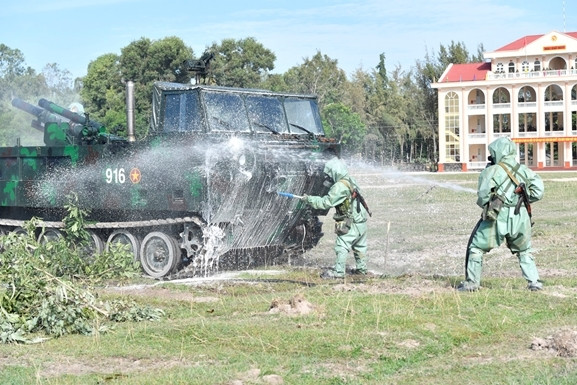 Sau khi tiếp cận mục tiêu, các chiến sĩ bộ đội phòng hóa nhanh chóng gỡ ngụy trang; sử dụng súng phun bàn chải, súng phun vòi rồng thực hành tiêu tẩy vũ khí, trang bị.
