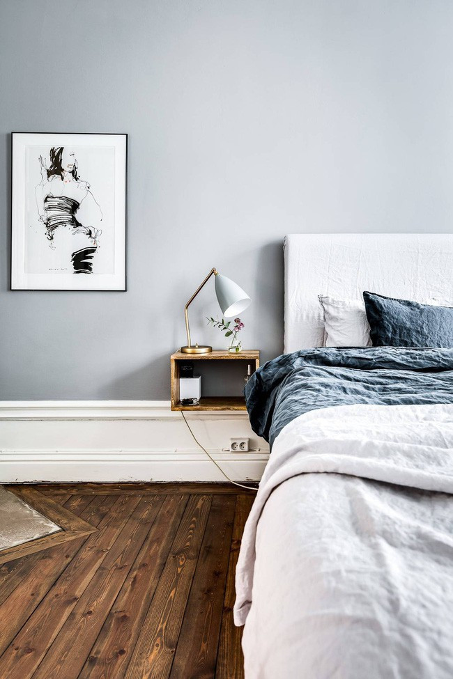 Đầu giường phòng ngủ điểm xuyết nhành hoa trang trí tinh tế.