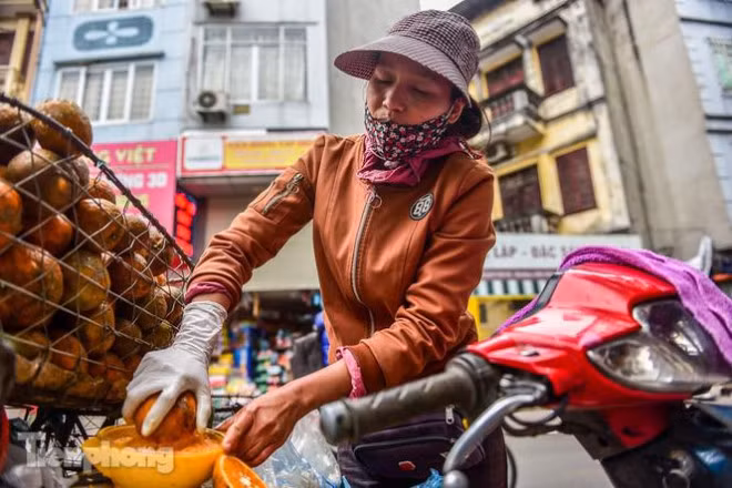 Rảnh tay, chị Diễm lại mang cam ra vắt.