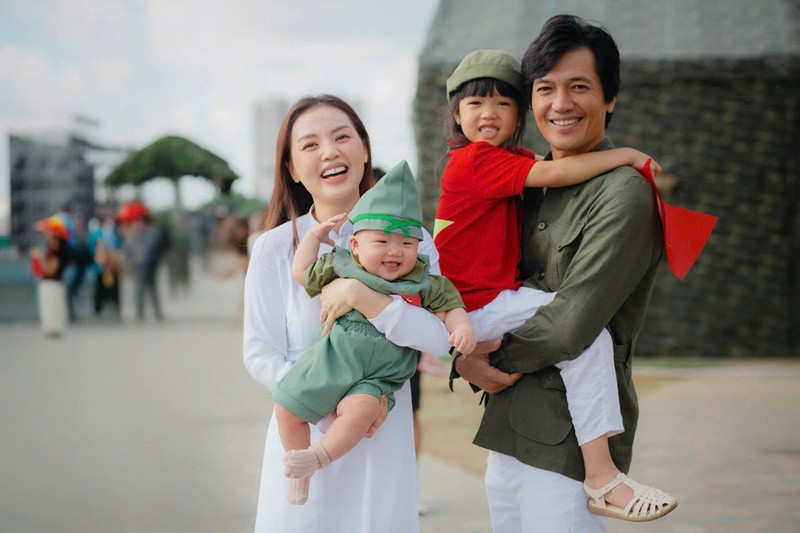 Linh Phi chia sẻ: “Có thể bây giờ các con chưa hiểu nhưng mai sau khi nhìn lại những hình ảnh này mong 2 em bé sẽ thấy kiêu hãnh khi mình được chứng kiến cột mốc đáng nhớ của đất nước và càng thêm yêu quê hương Tổ Quốc”. Ảnh: FB Quang Tuấn.