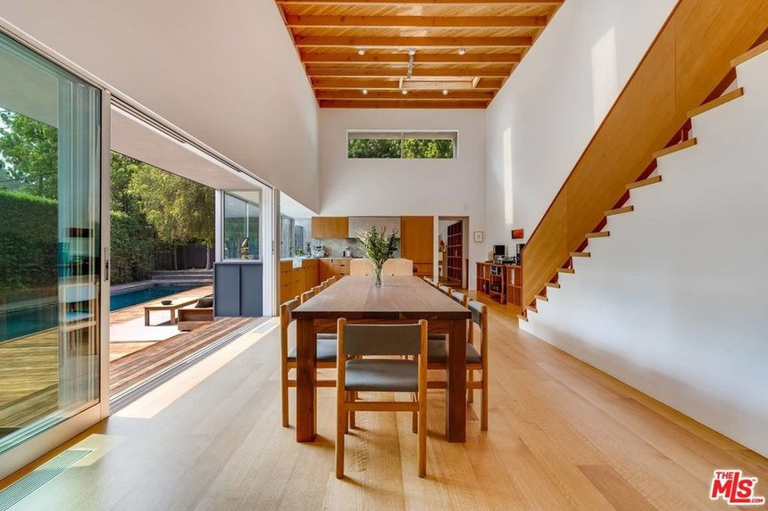 Phòng ăn và nhà bếp được tích hợp trong một không gian rộng lớn nằm sát hiên nhà. Sàn gỗ cứng khiến khu vực này trở nên ấm cúng và trang nhã hơn.