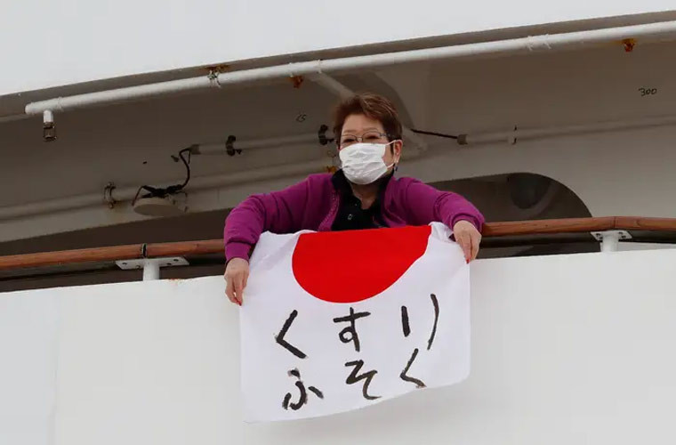 Một số người trên du thuyền treo những tấm biển ghi: “Thiếu thuốc!” hay “Cảm ơn truyền thông”.