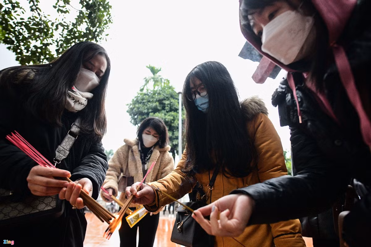 Châm và Ngọc (áo vàng) tới phủ Tây Hồ để dâng hương đầu năm. "Mình chỉ mới quay lại Hà Nội sau kỳ nghỉ Tết. Phủ Tây Hồ là nơi đầu tiên mình đi lễ. Nghe nói ở đây linh thiêng nên mình tới để xin công danh, sự nghiệp", Ngọc nói.