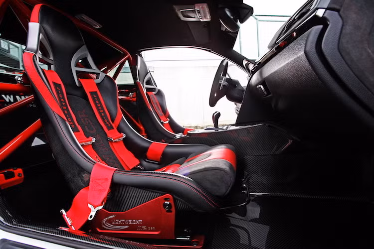"Chất" xe đua của M2 CSR được thể hiện rất rõ qua cặp ghế ngồi thể thao với khung bằng sợi carbon siêu nhẹ, cùng với dây đai an toàn 4 điểm. Ở phía sau lưng ghế trước, hàng ghế thứ 2 đã bị loại bỏ và thay thế bằng bộ khung thép gia cường.