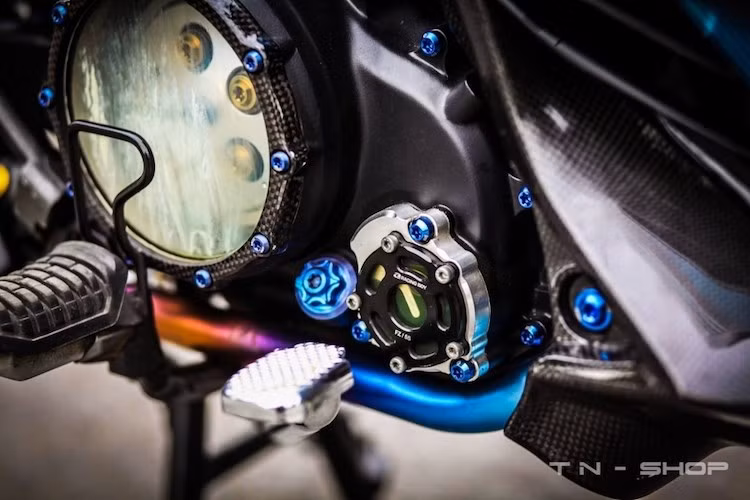 Phần lườn dưới được ốp Carbon Fiber, ngay bên cạnh là nắp nhớt CNC của Racing Boy. Lốc nồi trong suốt cũng được ốp Carbon và sử dụng ốc titan.