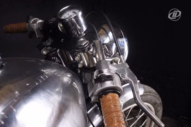 Theo đúng phong cách cafe racer, chiếc xe 2 kỳ "xã hội chủ nghĩa" được thay ghi-đông cao bình thường thành tay lái clip-on được hàn trực tiếp vào ti phuộc. Nằm hai bên tay lái là những dải da được cuốn thành bao tay đầy chất cổ điển, trong khi bảng đồng hồ của chiếc xe chỉ có một đồng hồ duy nhất.