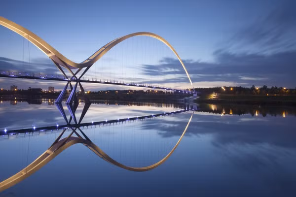 Cầu Infinity (Vô cực), thuộc thị trấn Stockton–on-Tees, Anh, phản chiếu dưới mặt nước trong xanh, tạo nên cấu trúc mái vòm đối xứng hoàn hảo.