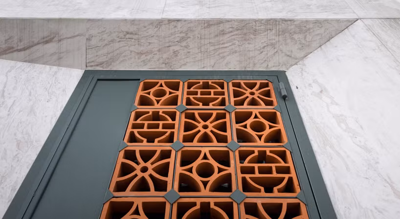 Cánh cửa tạo điểm tương phản giữa đá cẩm thạch và gạch đất nung.