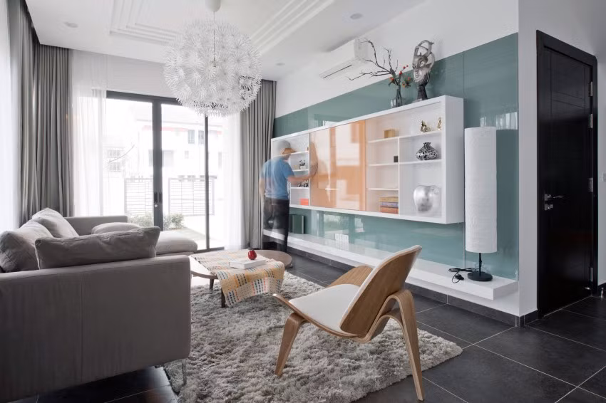 Không gian phòng khách khá hẹp nên kiến trúc sư đã sử dụng kính (độ phản xạ thấp) nhằm tạo chiều sâu cho không gian khi ngồi tại sofa.