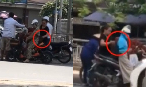 Hình ảnh đối tượng Thanh (khoanh đỏ) đang thực hiện hành vi móc túi của mình. Ảnh cắt từ clip.