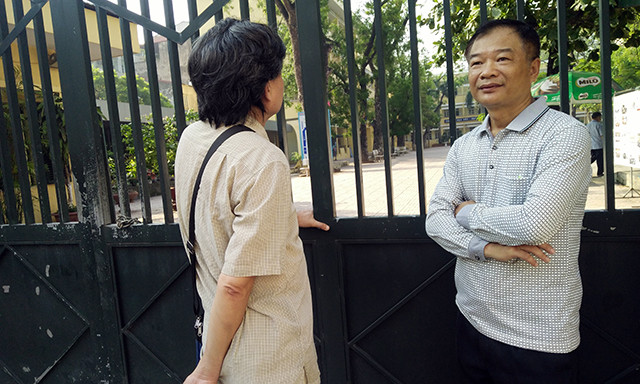 Ông Dũng (phải) và ông Công (trái), phụ huynh của hai thí sinh tại điểm THPT Yên Hòa, đợi con trước cổng trường. Cả hai phụ huynh chia sẻ, với lực học của con em mình cháu có thể tự tin làm bài. Tuy nhiên, trường hợp nếu không đỗ vào trường công, vẫn có thể đưa cháu vào học trường tư.