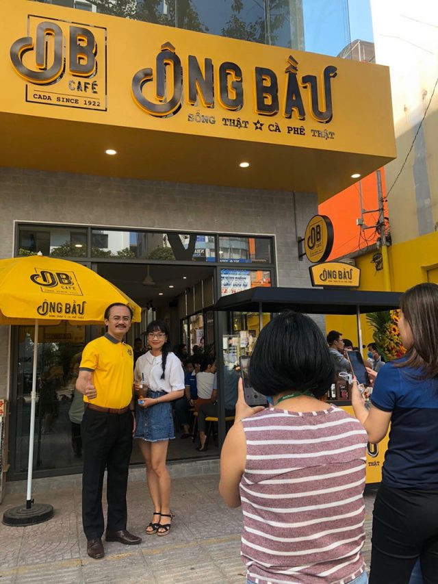  Hầu hết khách hàng mua cà phê mang đi hay uống tại quán, già hay trẻ... đều "đòi" chụp ảnh với "ông bầu" Võ Quốc Thắng. Bầu Thắng cũng tạo dáng chuyên nghiệp chiều khách. 