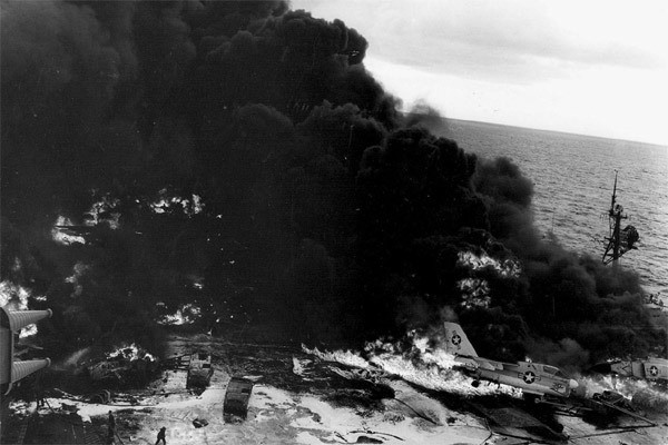 Hỏa hoạn lan rộng do nhiên liệu JP-5 cháy ở phía trên tràn xuống đã kéo theo nhiều vụ nổ. Khi một quả bom nặng gần 227kg và một giá đỡ 3 viên đạn đa năng Mk 82 phát nổ, chúng tạo ra một hố có kích thước 5,5m x 6,7m trên sàn bay của siêu hàng không mẫu hạm và phá vỡ một bồn chứa 6.000 gallon nhiên liệu của một máy bay chở dầu.