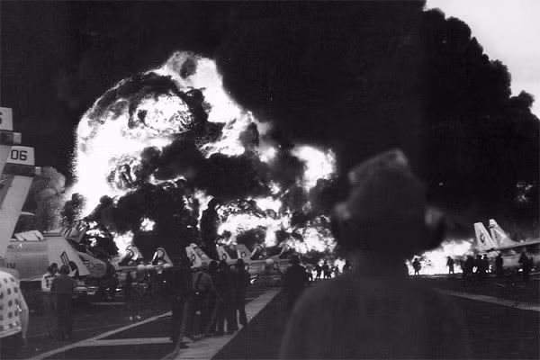 Ngay phía trước bức tường lửa là một chiếc F-4 Phantom. Hai cánh máy bay đều mở ám chỉ phi hành đoàn đã thoát ra ngoài an toàn. Phía bên trái là chiếc oanh tạc cơ A-7 Corsair với mạn phải đã bị phá nát.