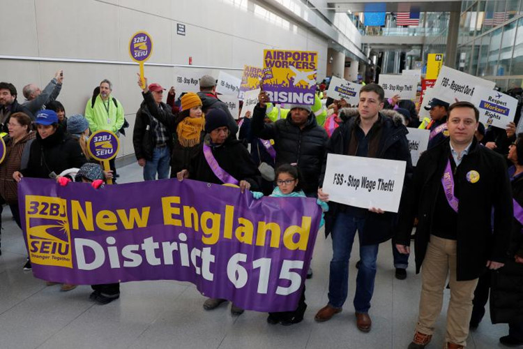 Nghiệp đoàn công nhân và nhân viên sân bay tham gia cuộc biểu tình cho nhân viên chính phủ liên bang làm việc mà không được trả lương tại Sân bay Logan ở Boston, Massachusetts, ngày 21/1. Bị kẹt giữa cuộc chiến đảng phái này là hàng trăm nghìn nhân viên, công nhân liên bang và nhiều người khác khi tất cả mọi thứ, từ hoàn thuế đến viện trợ nông trại, đều bị đình trệ.