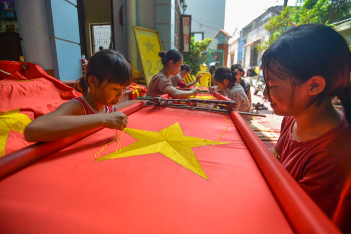Theo chị Vương Thị Nhung (hộ gia đình làm cờ Tổ quốc thêu tay): "Hiện nay, nhiều nơi sử dụng công nghệ làm nên những giá cờ nhanh, gọn và rẻ nhưng gia đình tôi vẫn giữ nguyên cách làm cờ truyền thống bằng cách thêu tay".