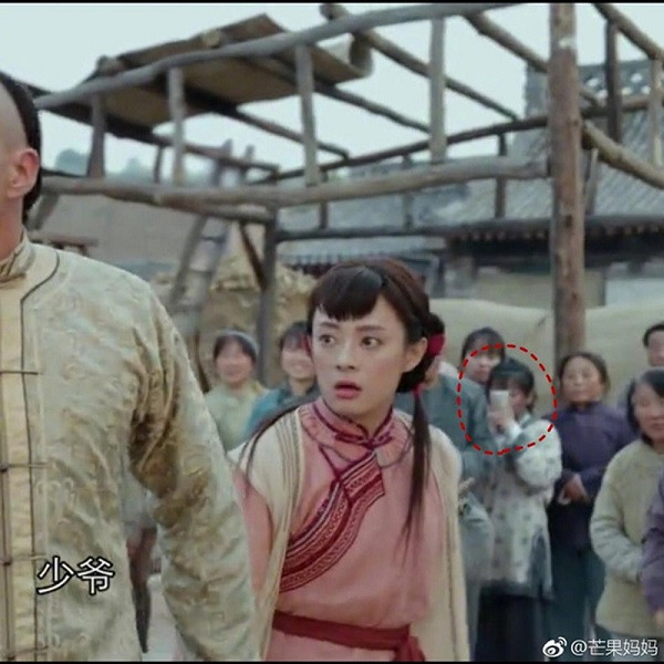 Đây không phải là lần đầu tiên điện thoại xuất hiện trong một bộ phim cổ trang Hoa ngữ. Tập 11 của bộ phim “Năm ấy hoa nở trăng vừa tròn” từng gẫu bão màn ảnh nhỏ đạt rating cao đột biến, không chỉ bởi tình tiết gay cấn, mà còn ở chi tiết một diễn viên quần chúng rút máy điện thoại ra chụp ảnh hai nhân vật chính, sau đó vội vàng cất đi. Ảnh: sina