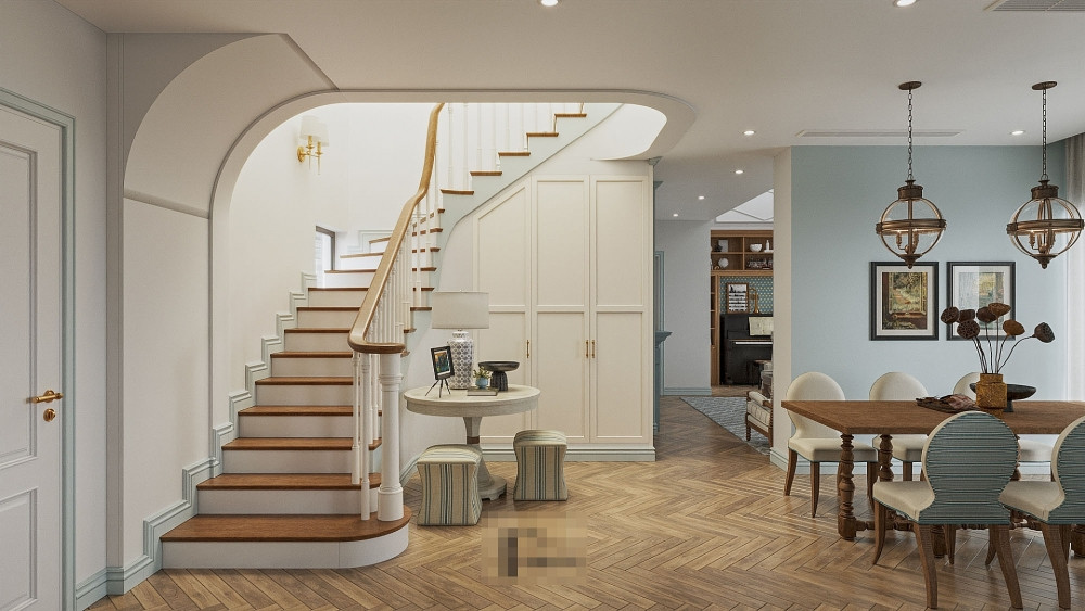 Không gian bếp+bàn ăn gần cầu thang tay vịn gỗ kiểu cổ điển. Gầm cầu thang được bố trí các hộc tủ đựng đồ và bàn tròn bày đồ decor.