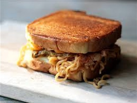 Sandwich mì tôm ăn cũng rất lạ miệng và ngon bất ngờ. Nguyên liệu của món bánh sandwich mì tôm cần: 2 nắm mì gói, 1 quả trứng, 2 miếng thịt xông khói, 3 lát phô mai, tương ớt, bơ, hộp hình chữ nhật để nén mì.