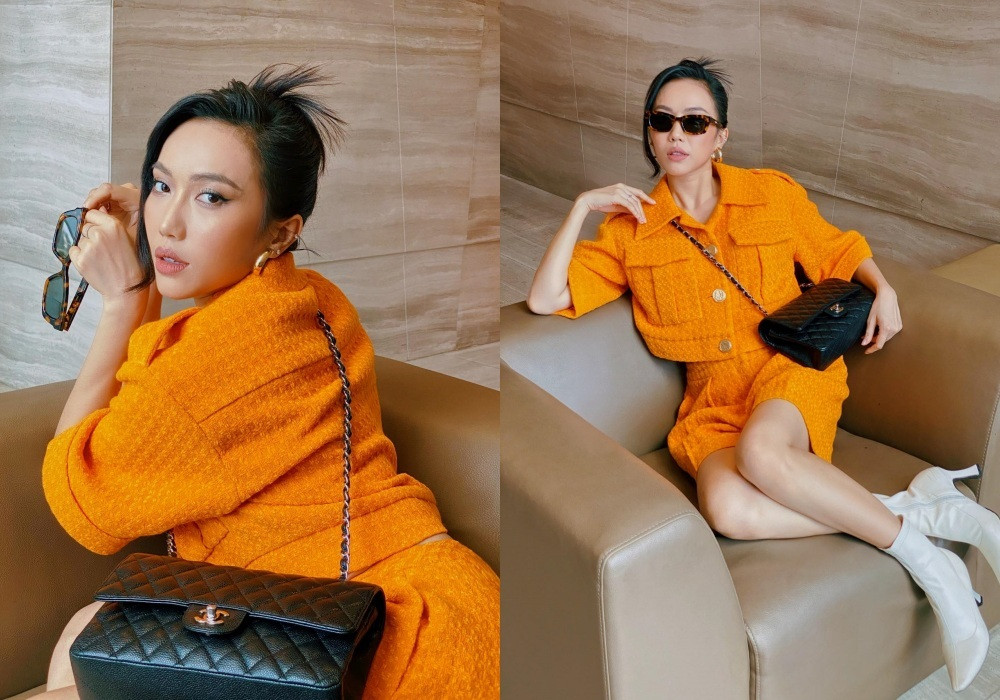 Nữ diễn viên Diệu Nhi trông khá sành điệu với bộ trang phục màu cam mix với túi xách Channel màu đen.