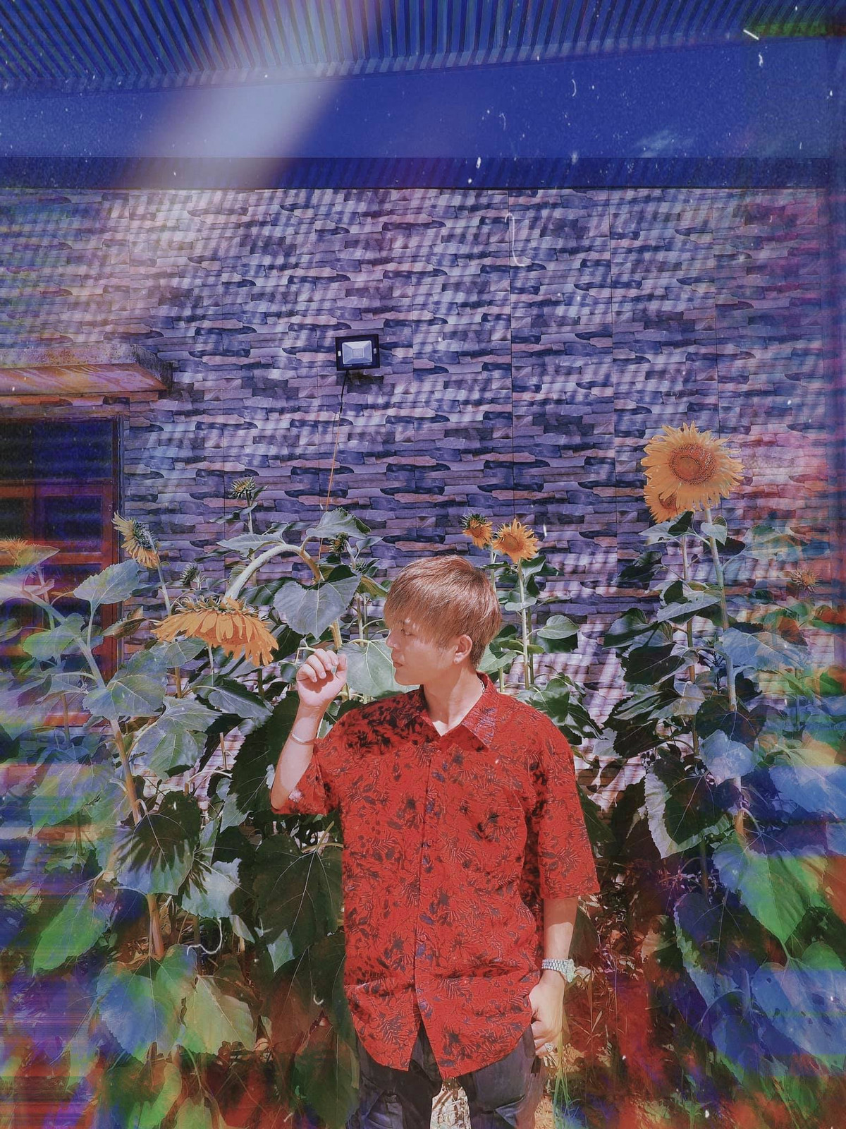 Nam ca sĩ trông khá hào hoa với chiếc áo sơ mi đỏ họa tiết đen.