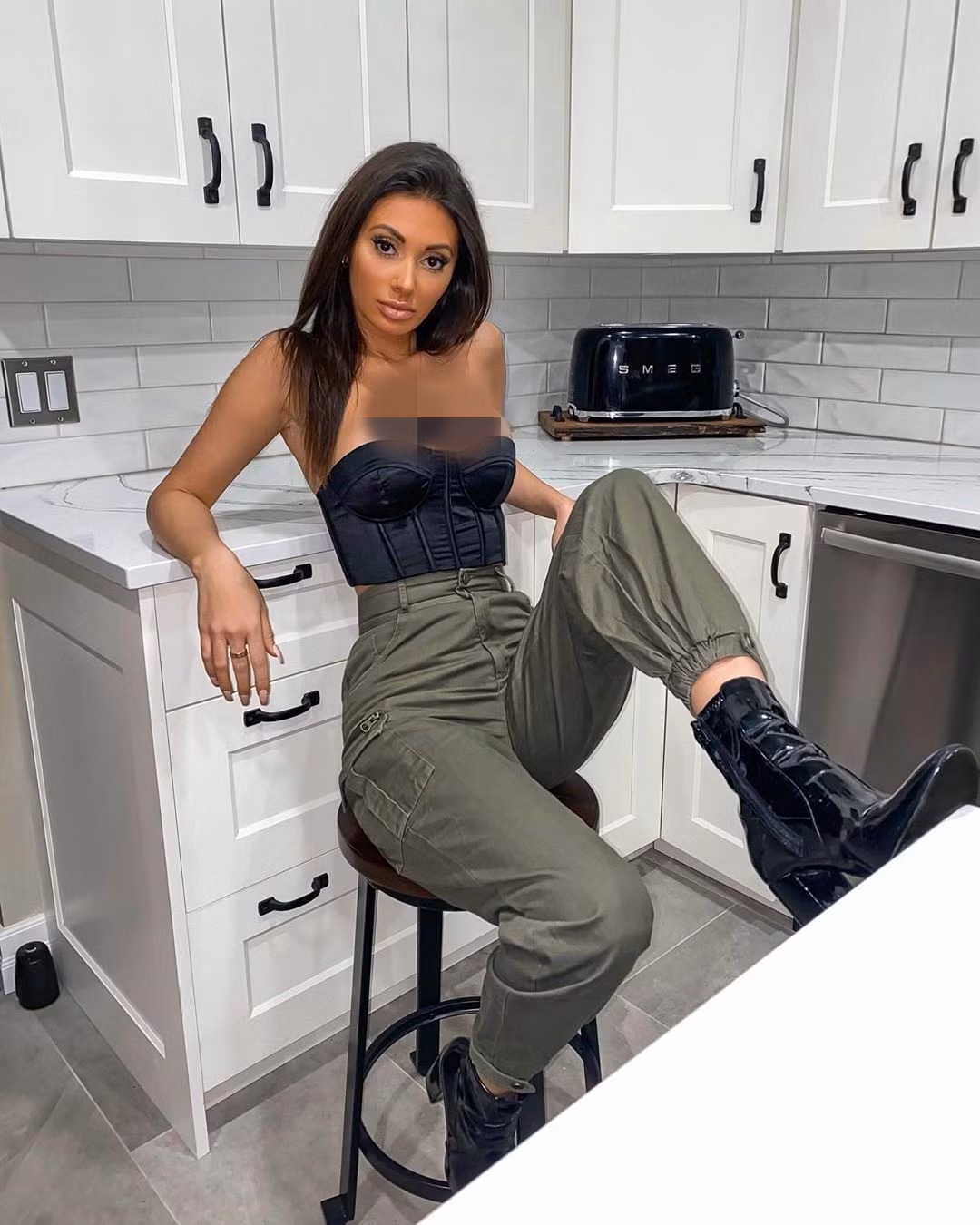 Chiếc áo cúp ngực kiểu corset phô trương vòng một đầy đặn của cô.