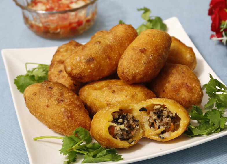 Bánh rán mặn từ lâu đã trở thành món bánh nóng hổi quen thuộc khi trời se lạnh. Khi thưởng thức, bạn sẽ cảm nhận được sự hòa quyện hấp dẫn của vỏ bánh nóng giòn, nhân thịt bên trong thơm, mềm cùng nước sốt chấm chua ngọt cay. Ngoài bánh rán mặn, bạn có thể gọi thêm bánh rán ngọt kèm cốc trà đá mát lạnh.