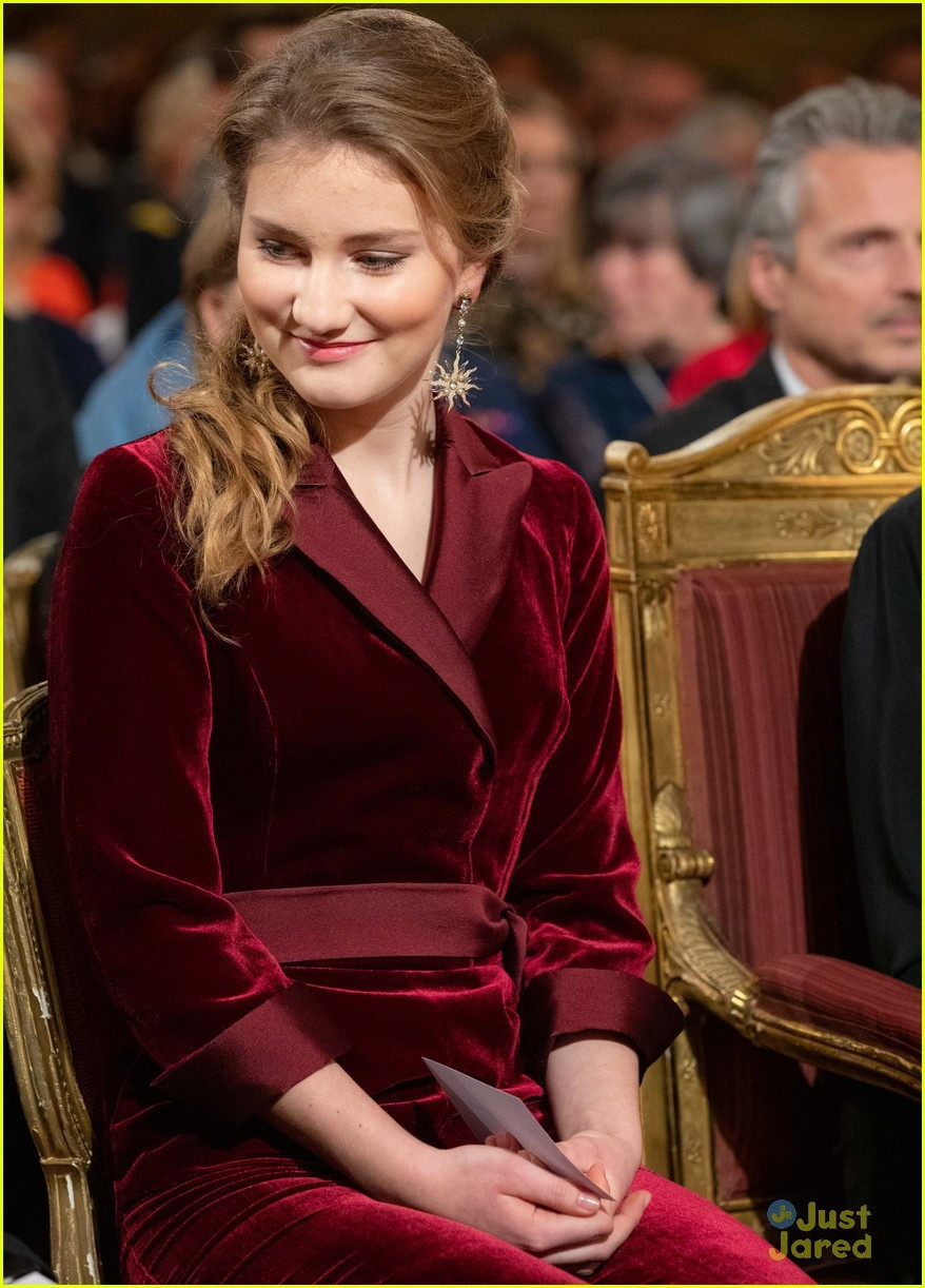 Công chúa Elizabeth mặc một váy nhung màu đỏ rượu vang sang trọng có viền ở cổ áo và hai tay.