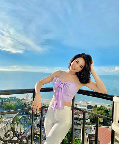 Thúy Ngân khoe vai trần gợi cảm với áo nơ to bản hot trend. Trang phục tông tím được nữ diễn viên phối hợp nhịp nhàng cùng jeans trắng.