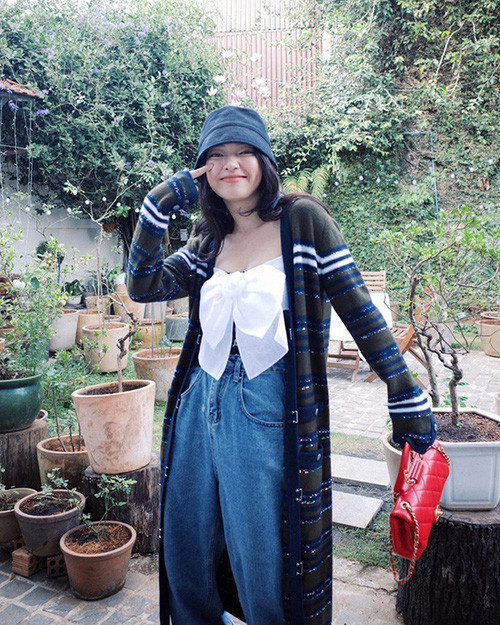Châu Bùi chọn cardigan dáng dài và jeans cổ điển để mix cùng chiếc áo nơ màu trắng.