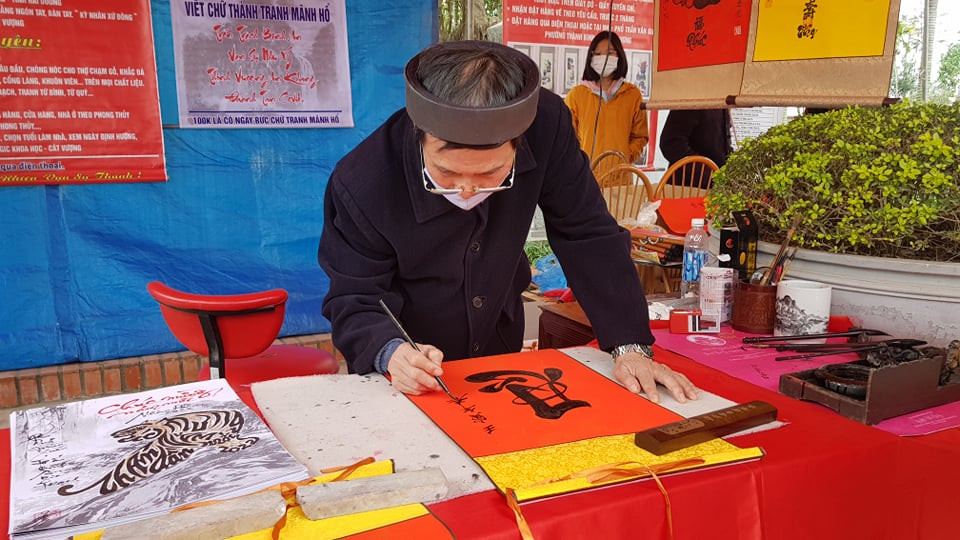 Tại khuôn viên đền Bia, ông Đồ vẫn miệt mài viết thư pháp cho chữ du khách.