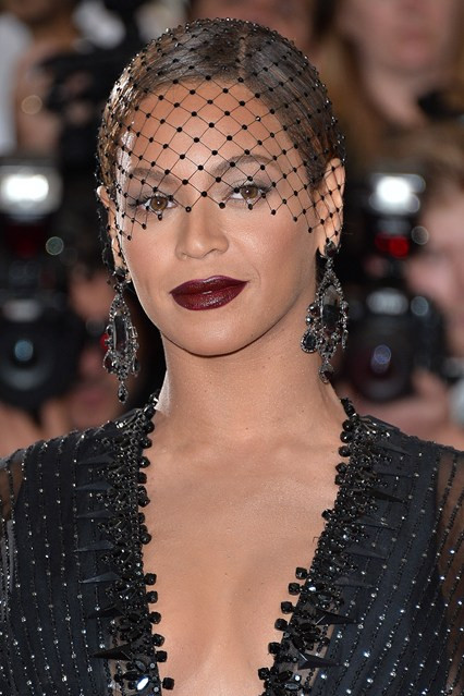 Rihanna xuất hiện ấn tượng với son môi sẫm màu và mạng che mặt.