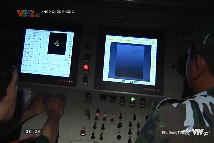 Hình ảnh bên trong bàn điều khiển của tổ hợp khí tài đánh đêm bán tự động. Được biết, bên cạnh khả năng phát hiện, thep dõi và bám bắt mục tiêu, tổ hợp này còn tích hợp hệ thống cò điện và máy nạp đạn tự động cho pháo phòng không 37mm cho phép người điều khiển có thể khai hỏa trực tiếp từ bên trong xe chỉ huy. Nguồn ảnh: VTV2.