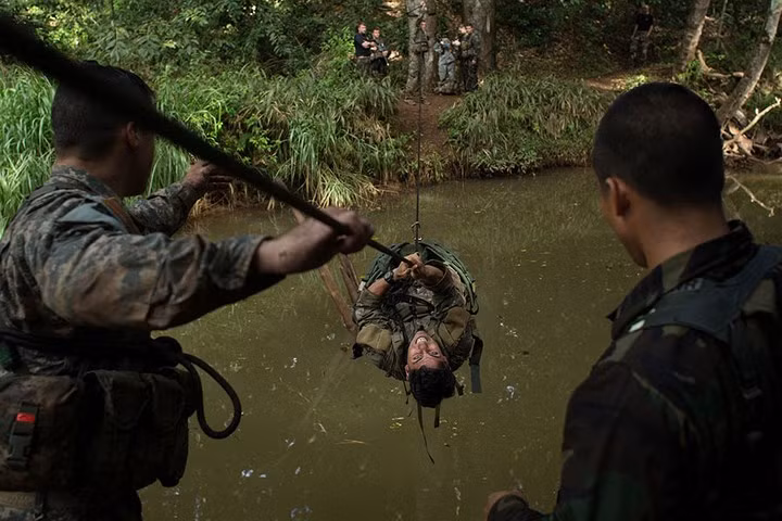 Binh sĩ Mỹ hỗ trợ nhau băng qua một con sông nằm trong khu vực huấn luyện tại Hawaii.