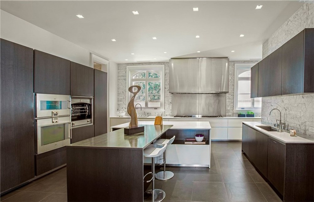 Nhà bếp rộng lớn, sang trọng với những trang thiết bị nấu nướng hiện đại, cao cấp được tích hợp với chiếc tủ gỗ khổng lồ.