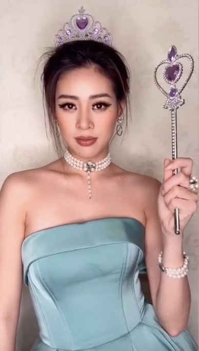 Người đẹp 25 tuổi chọn bộ đầm cúp ngực màu xanh, đội vương miện và sử dụng nhiều đồ trang sức như vòng cổ ngọc trai, vòng tay, khuyên tai.