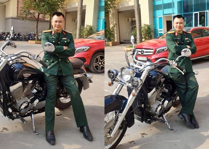 Nghệ sĩ Tự Long tạo dáng bên xe mô tô.