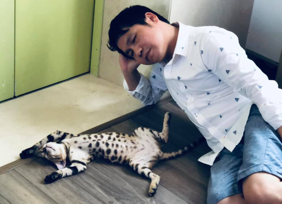 Thấy dáng ngủ mèo cưng độc đáo, Trọng Tấn viết: "Êm đềm một giấc ngủ trưa". NSND Lê Tiến Thọ góp thêm câu thứ 2, tạo thành cặp thơ lục bát: "Ngoài kia náo nhiệt, nắng mua kệ đời".