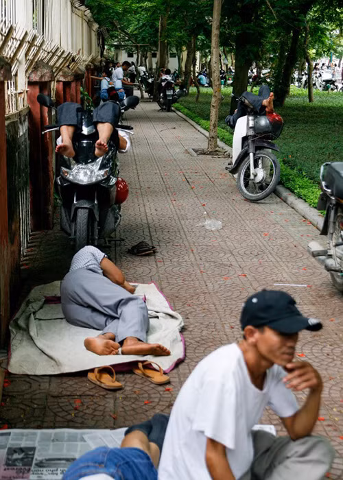 Nhiều người từ xa về, ngại vào quán giải khát dễ tốn kém nên thường tranh thủ nằm, ngồi ngay tại cổng trường chờ thí sinh kỳ thi THPT quốc gia.