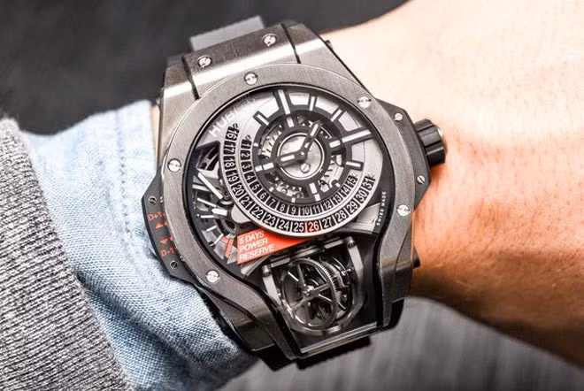 Hublot MP-09 Tourbillon Bi-Axis sở hữu mức giá 280.000 USD với 3 phiên bản có giới hạn bằng vàng, titan và kim cương. Bộ phận hiển thị giờ nằm ở góc trên bên phải với 2 kim chỉ giờ và phút màu đen trắng, phía dưới là phần ngày được chia làm 2 hàng rõ ràng.