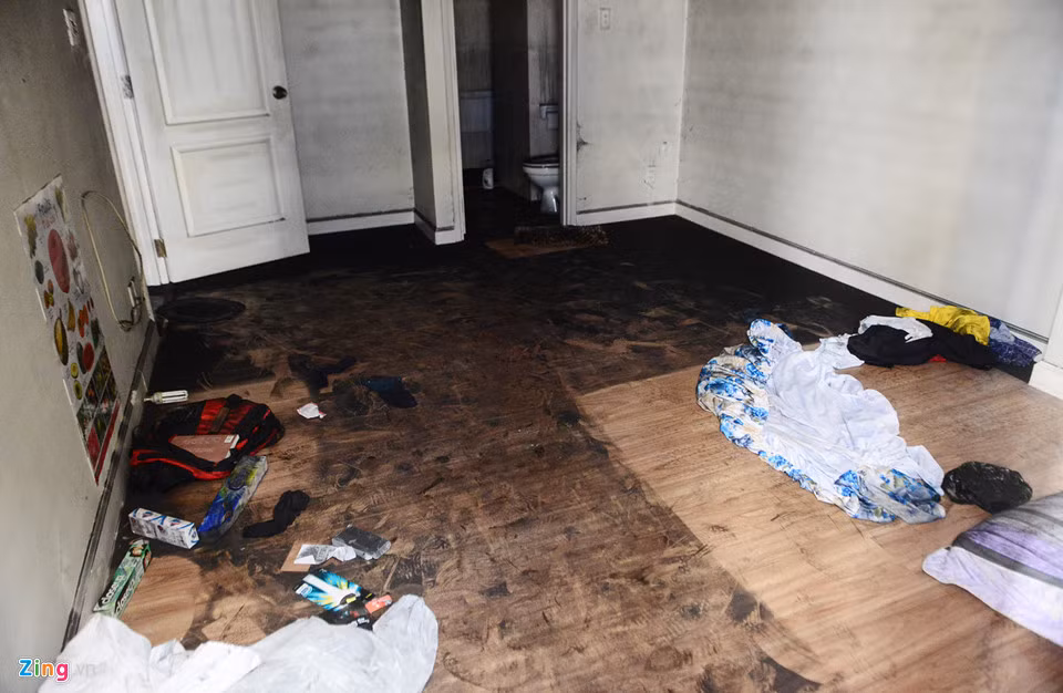 Một phòng căn hộ tại tầng 2 trong số những căn tại khu vực giữa block A và B từ mặt sàn đến tường còn dính tro bụi đen khịt. Đồ đạc thiết yếu đã được cư dân chuyển đi, chỉ còn lại căn phòng trống.