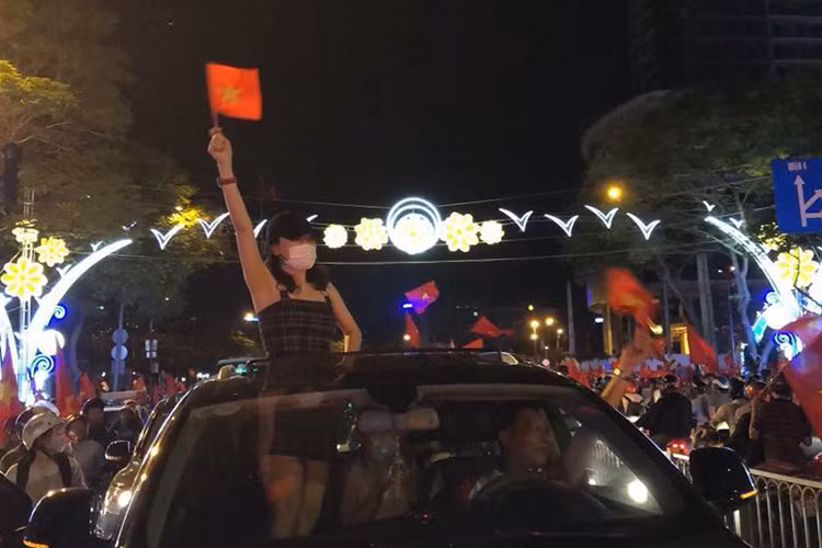 Chiến thắng của U23 Việt Nam tại bán kết giải U23 châu Á làm nức lòng người hâm mộ Việt Nam. Hòa chung niềm vui cùng người dân cả nước, loạt sao Việt xuống đường đi bão. Trong ảnh, Mỹ Tâm giơ cao cờ Tổ quốc và liên tục hò reo cùng đám đông.